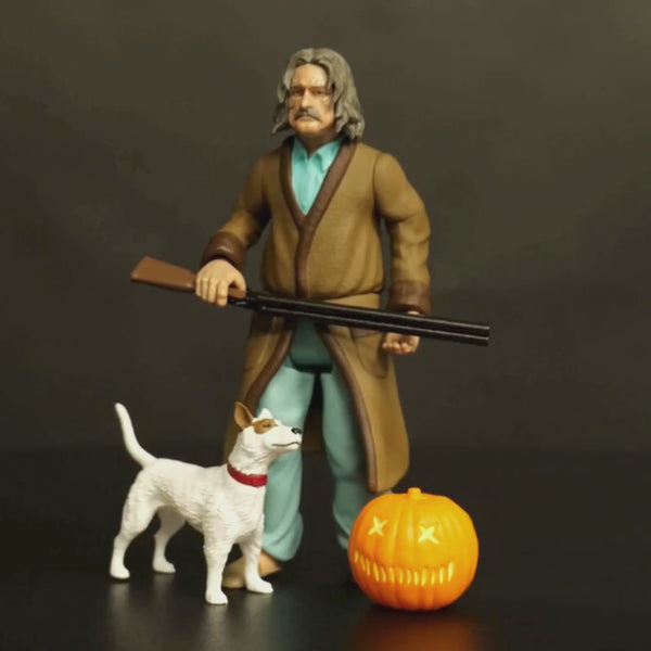 video 360 degree Trick r Treat 5 inch  Kreeg figure. shown with accessories.  Middle-aged man with shoulder-length light brown hair and mustache. Wearing pale green pajama shirt and pants, brown robe, tan slippers.  Holding a shotgun in both hands, white and brown dog with red collar standing at right foot, orange jack o' lantern at left foot.